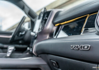 Close-up showing the passenger-side screen and dashboard badge in a 2025 Ram 1500 RHO