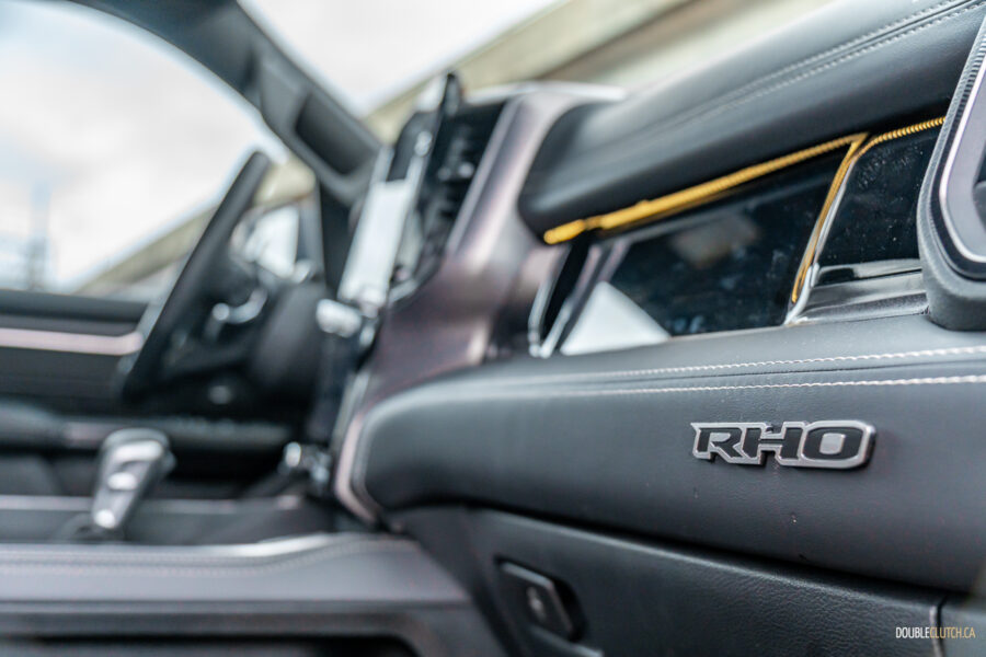 Close-up showing the passenger-side screen and dashboard badge in a 2025 Ram 1500 RHO