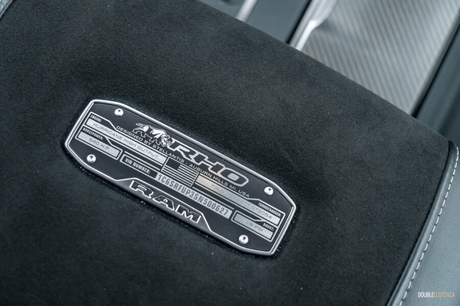 Close-up showing the armrest plaque in a 2025 Ram 1500 RHO