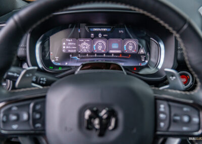 Close-up showing the digital gauge cluster and steering wheel in a 2025 Ram 1500 RHO
