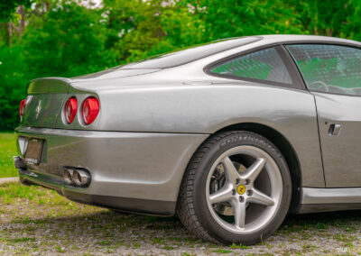 Cropped rear quarter view showing the roofline and rear haunches of a grey 1996 Ferrari 550 Maranello