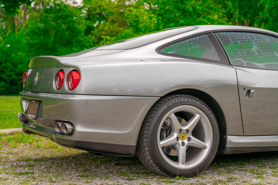Cropped rear quarter view showing the roofline and rear haunches of a grey 1996 Ferrari 550 Maranello