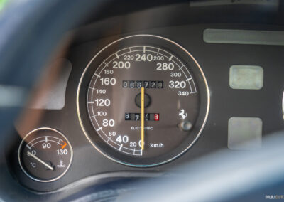 Close-up of the speedometer and engine temperature gauge in a 1996 Ferrari 550 Maranello
