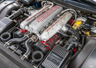 The iconic V12 engine under the hood of a 1996 Ferrari 550 Maranello