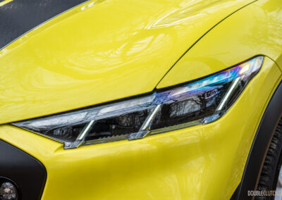 Close-up of the headlights on a yellow 2025 Ford Mustang Mach-E Rally