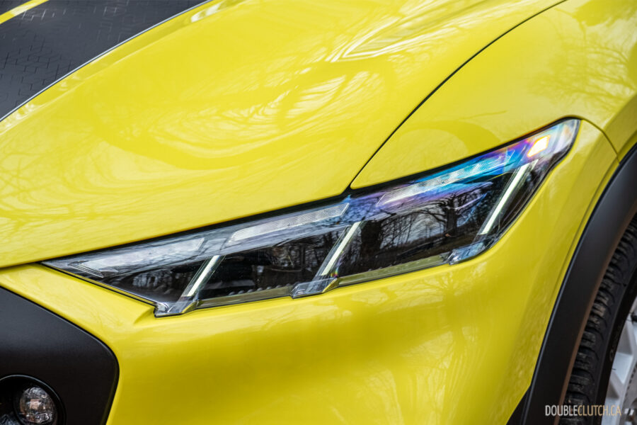 Close-up of the headlights on a yellow 2025 Ford Mustang Mach-E Rally