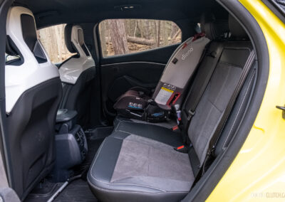 Interior view showing the rear seat area with a child seat installed in a 2025 Ford Mustang Mach-E Rally