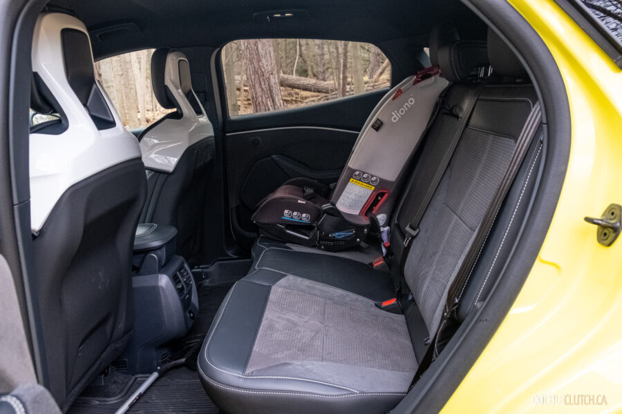 Interior view showing the rear seat area with a child seat installed in a 2025 Ford Mustang Mach-E Rally