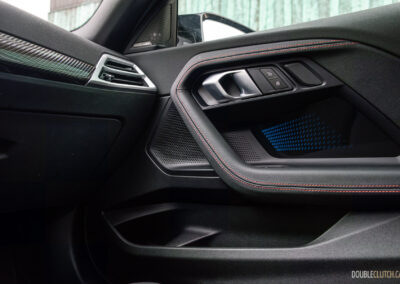 2025 BMW M240i xDrive interior passenger-side door panel view