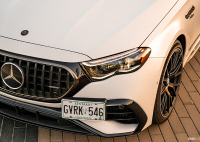 2025 Mercedes-AMG E 53 front corner close-up showing headlight, grille, front wheel