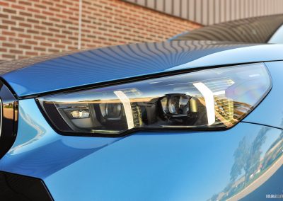 2025 BMW 540i Legacy Edition in Maldives Blue close up headlight