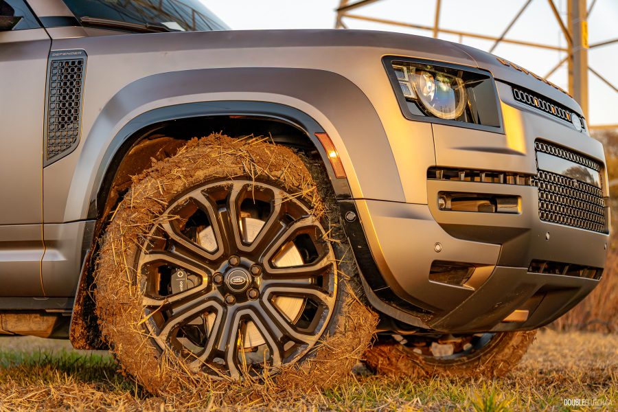 2026 Land Rover Defender OCTA in Petra Copper in mud